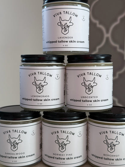 Stack of Viva Tallow whipped tallow skin cream jars with labels on a neutral background